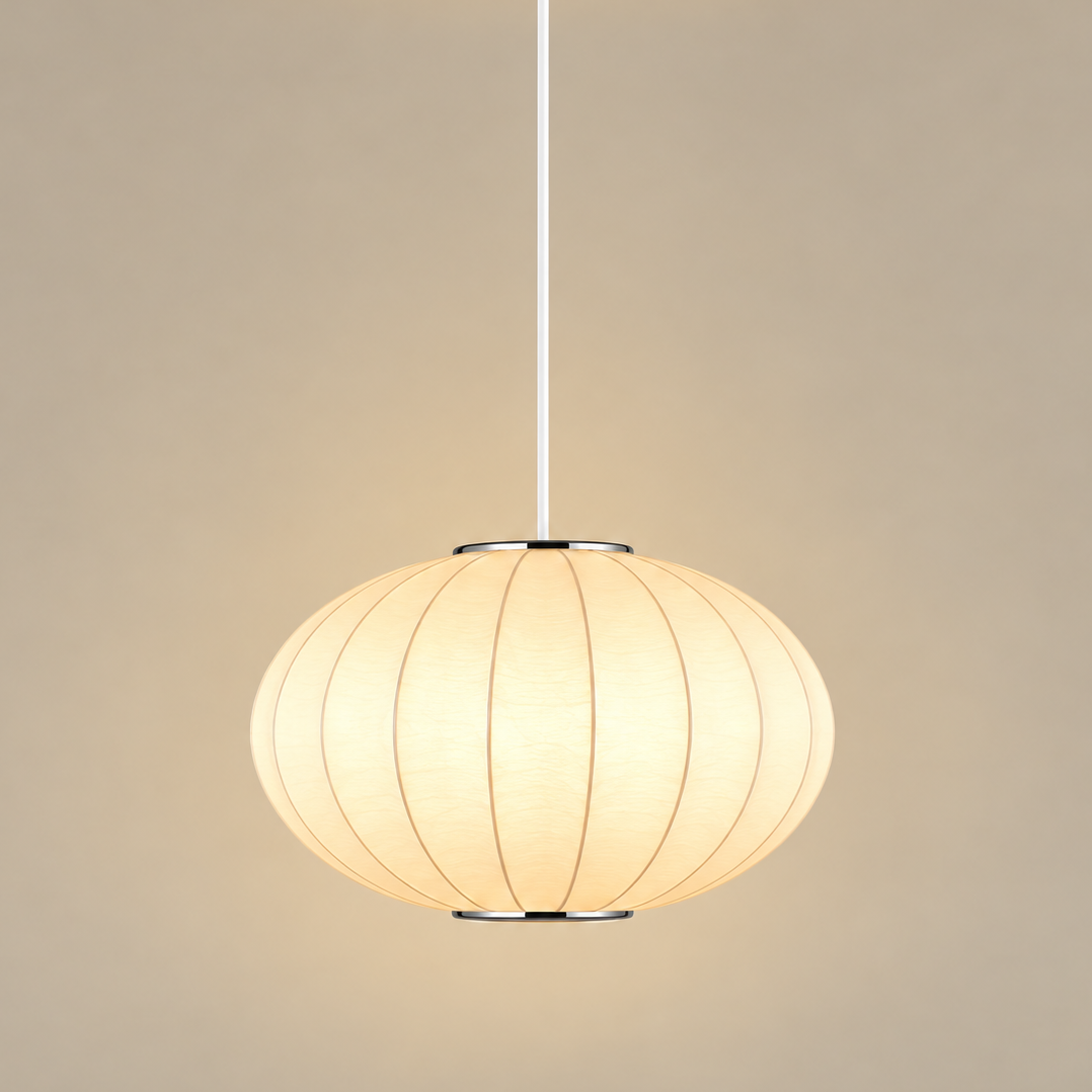 A modern spherical pendant light with a warm glowing cream paper lantern shade, suspended by a slim white cord from a white ceiling canopy against a solid beige background.