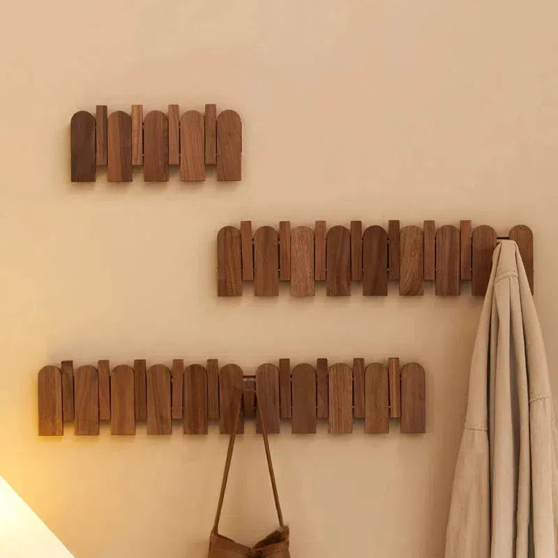 Picket Walnut Wood Coat Rack wall-mounted showing natural walnut grain and flip-down hooks folded and extended