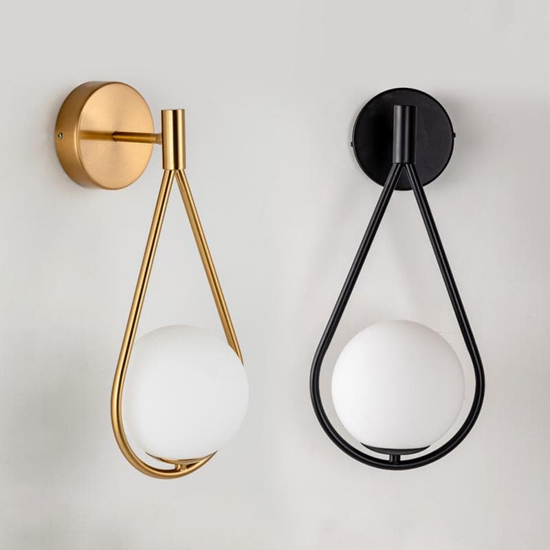 Copper and black loop shape wall lamps with a Frosted glass globe