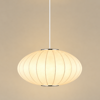A modern pendant light with a warm white ribbed dome shade, suspended by a slim white cord from a white ceiling canopy against a solid beige background.