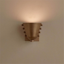 Metal wall sconce with wine glass silhouette casting soft ambient uplight in modern interior setting
