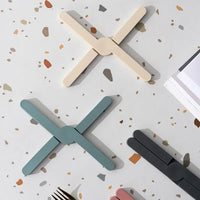 Foldable silicone heat resistant Crossfold Coaster Trivet, non-slip pot pan mat and coaster set in modern multi-color shades for kitchen table protection