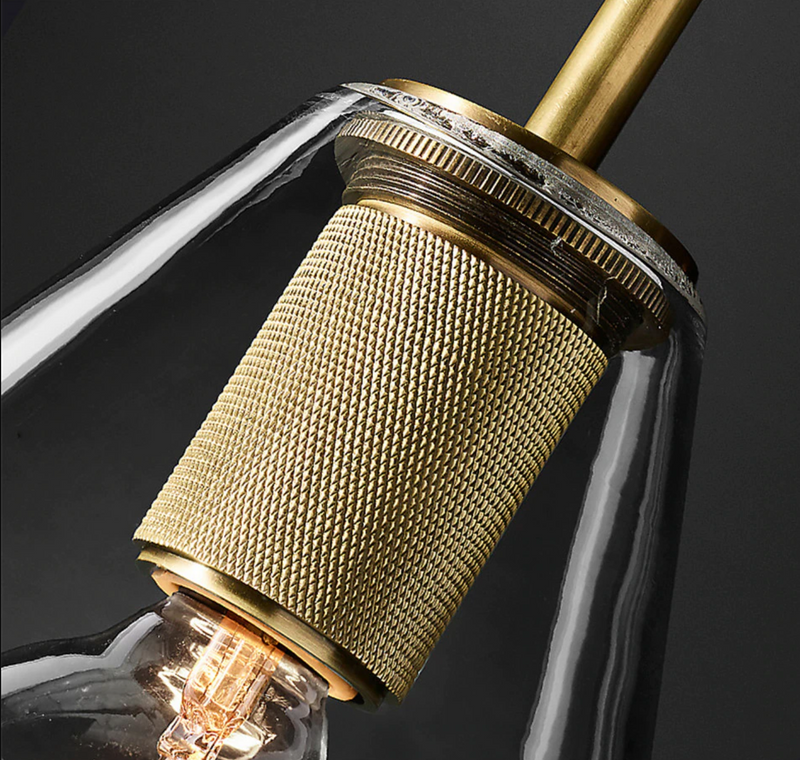 Wall-mounted double sconce with brushed brass finish and glass shades
