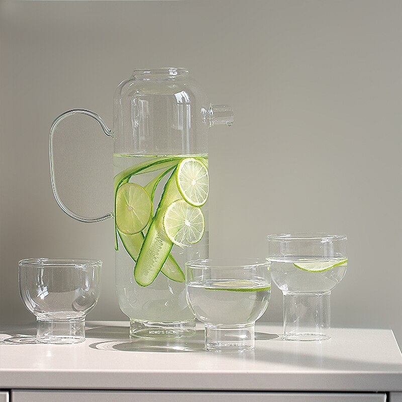 tall round clear glass pitcher and cup