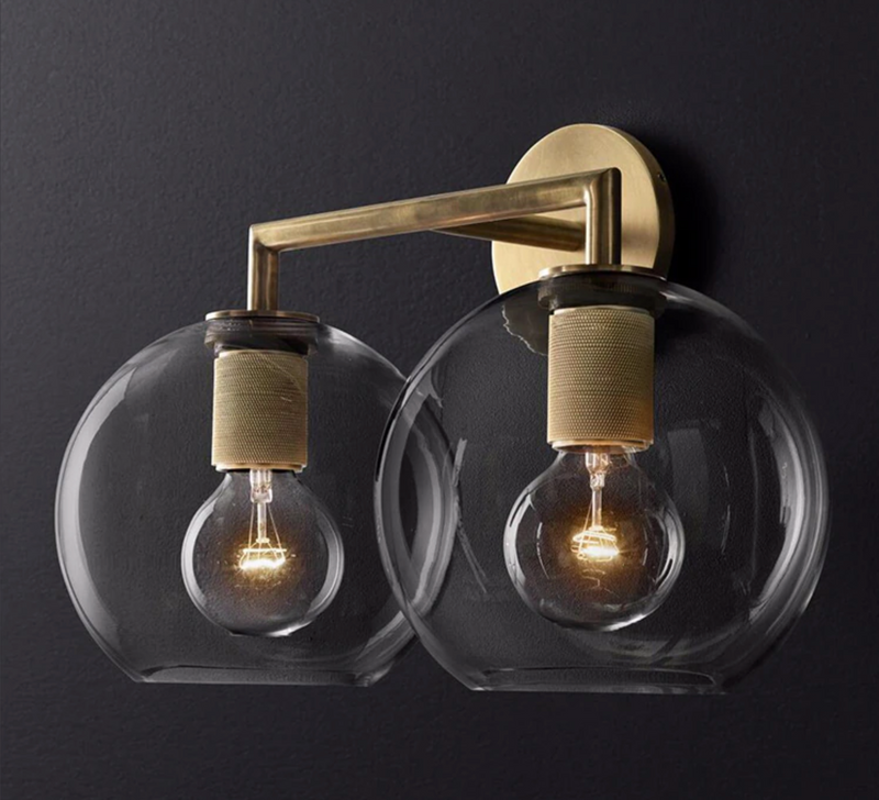industrial Wall-mounted double sconce with brushed brass finish and glass shades