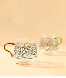 rounded clear glass van gogh-design mug with orange green handle