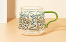 rounded clear glass van gogh-design mug with orange green handle