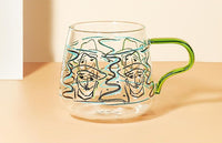 rounded clear glass van gogh-design mug with orange green handle