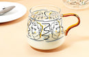 rounded clear glass van gogh-design mug with orange handle