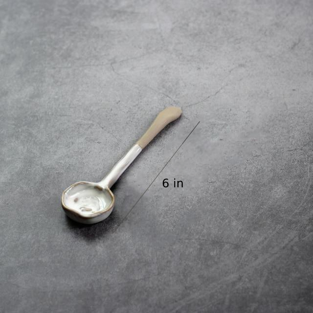 round abstract gold trim edges white ceramic spoon