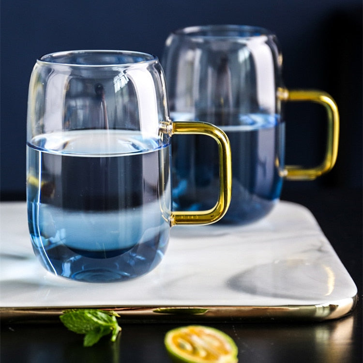 Blue glass pitcher and cups with gold handles for the modern kitchen