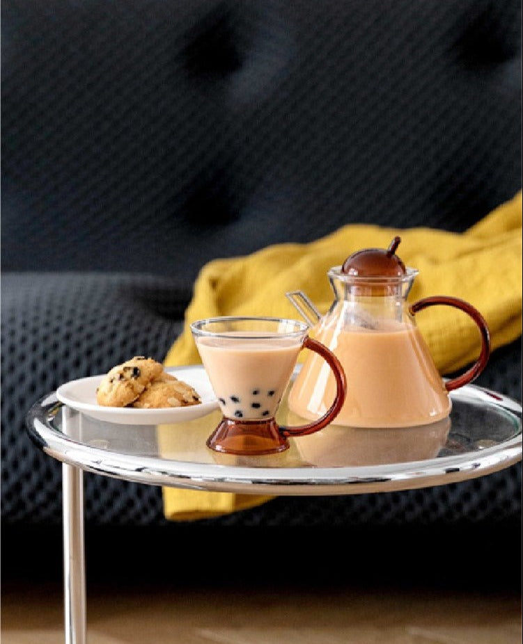 triangular clear borosilicate glass tea pot and cup with amber thin handle