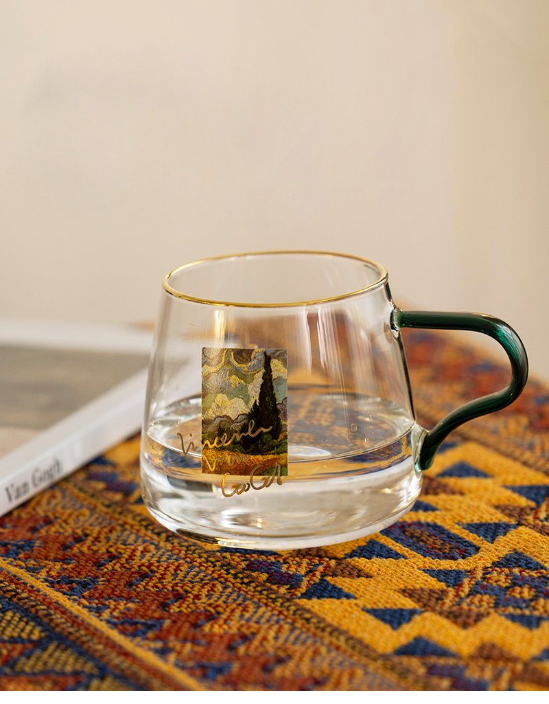 rounded clear glass van gogh-design mug with green handle